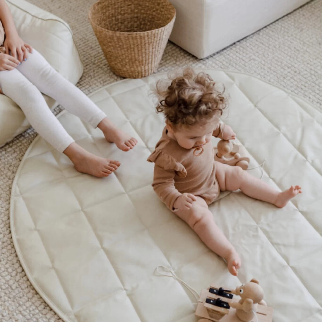 Baby seated on the Henlee Quilted best baby play mat during playtime.