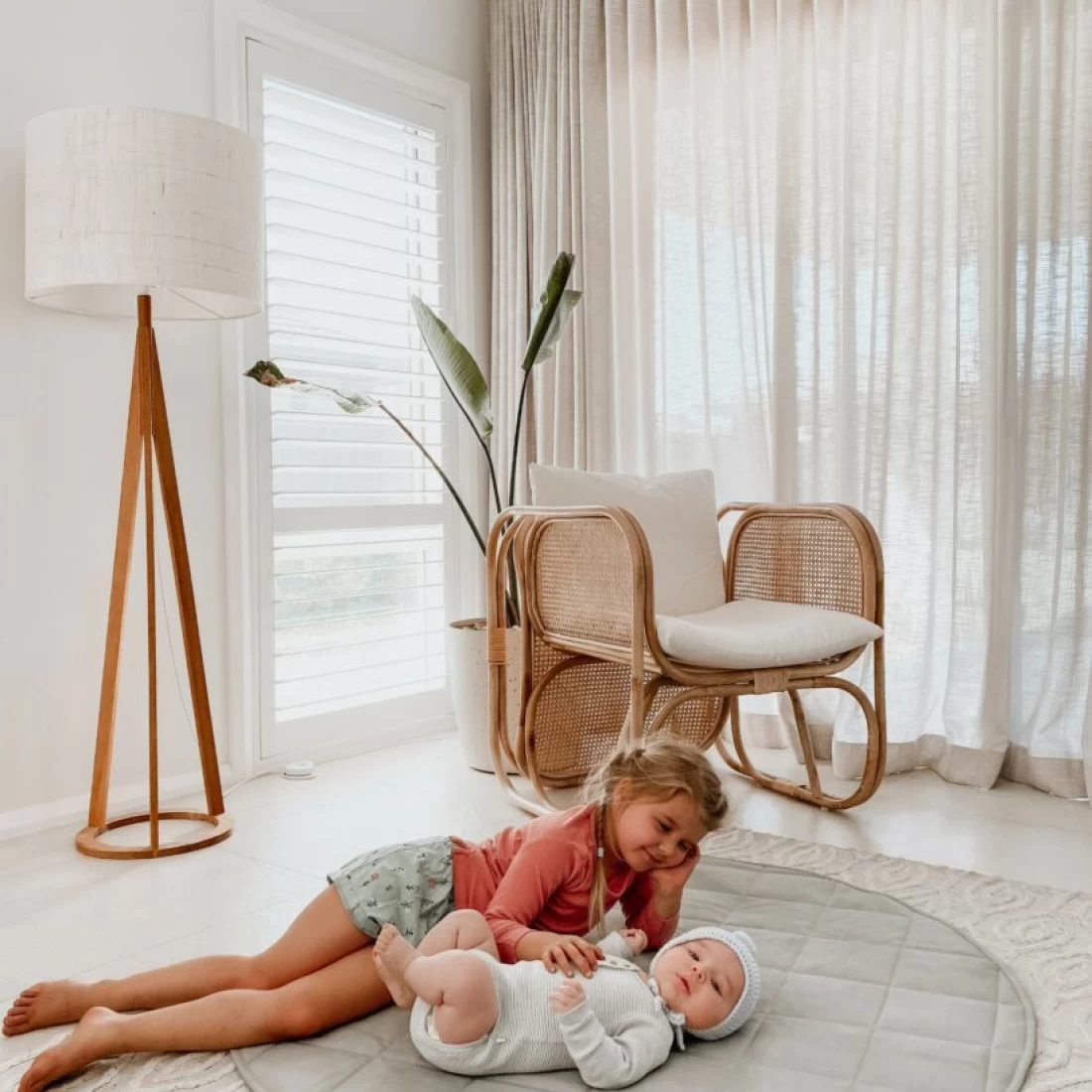 Toddler and baby relaxing together on the Henlee Quilted best baby play mat