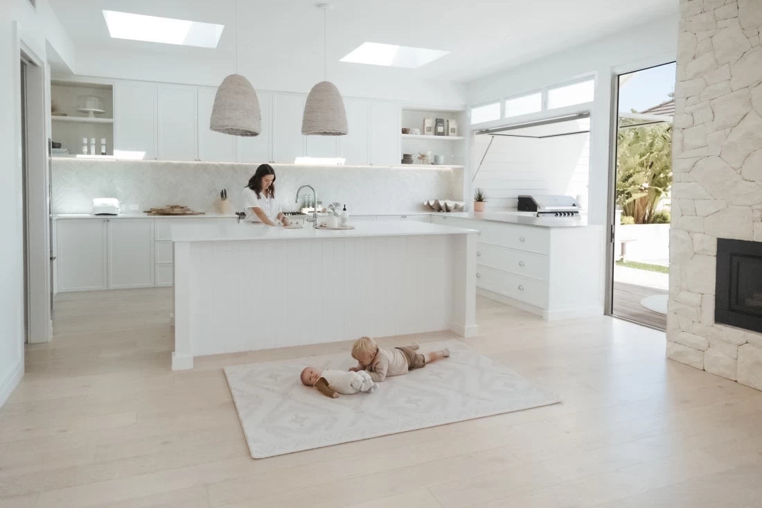 Baby lying on the Mikro Australia best baby play mat in a minimalist white house.