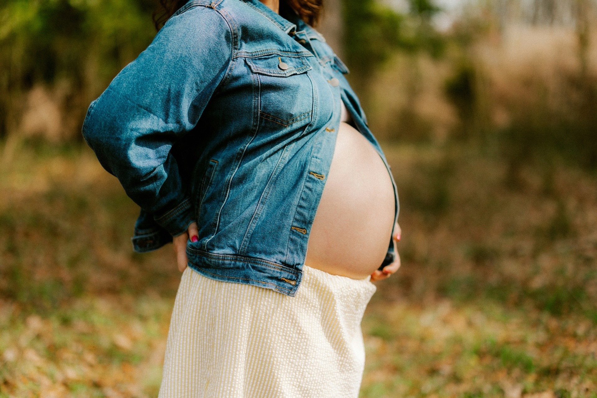 An Australian pregnant mum wearing a denim jacket
