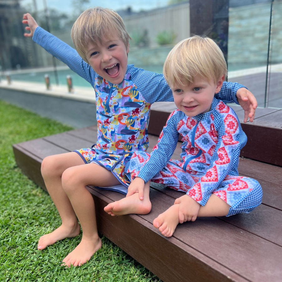 Two children dressed in Tyoub eco-friendly baby and toddler best swimwear, perfect for sustainable beach days.