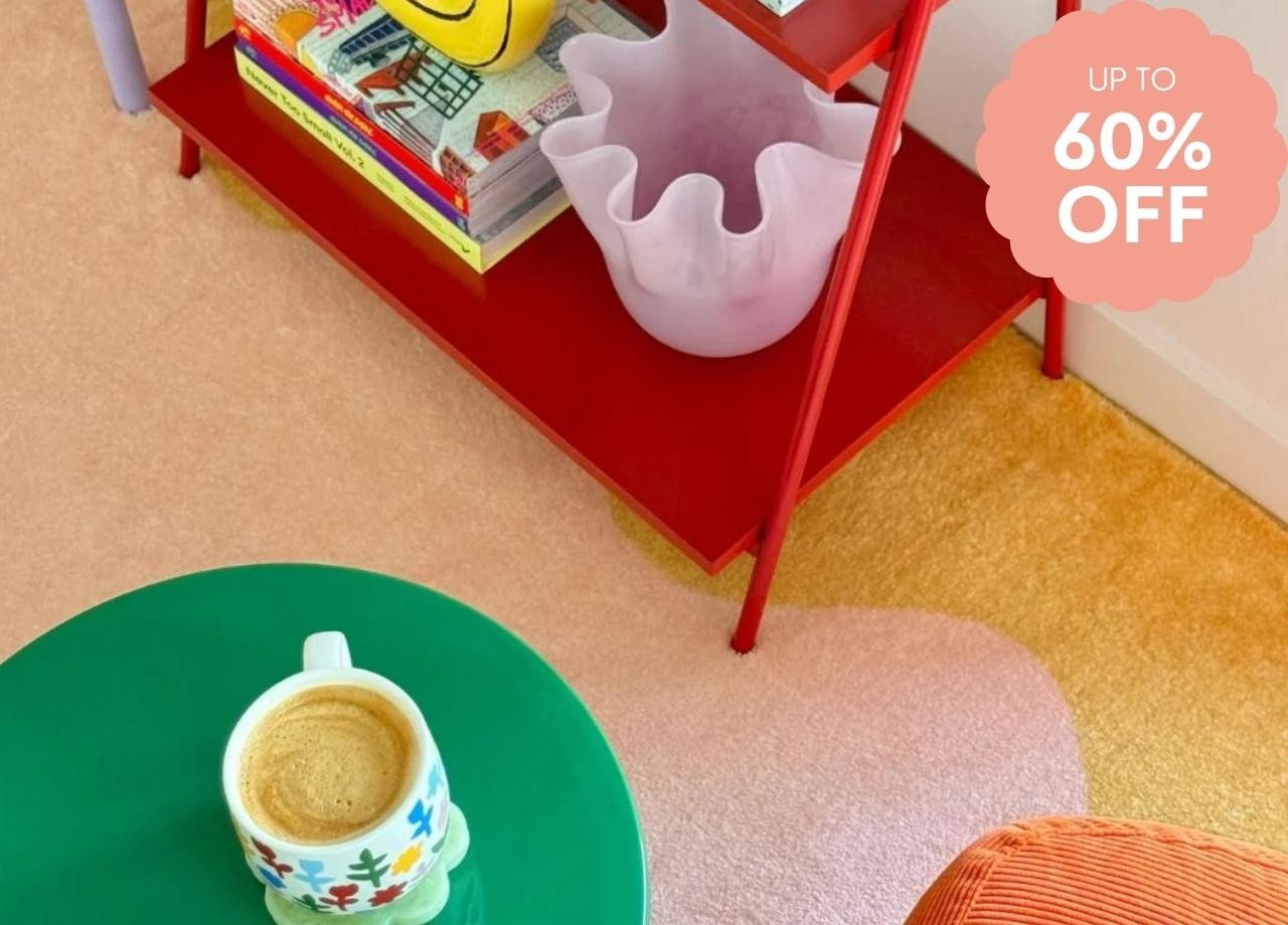a colourful rug with a green table and red bookshelf on it