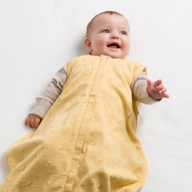 A baby in a wool summer sleeping bag