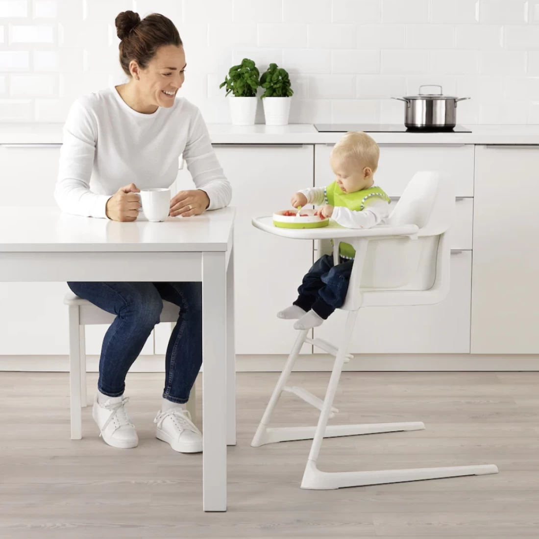 Mum and baby eating together, with baby sitting on the Ikea Langur Junior High Chair With Tray