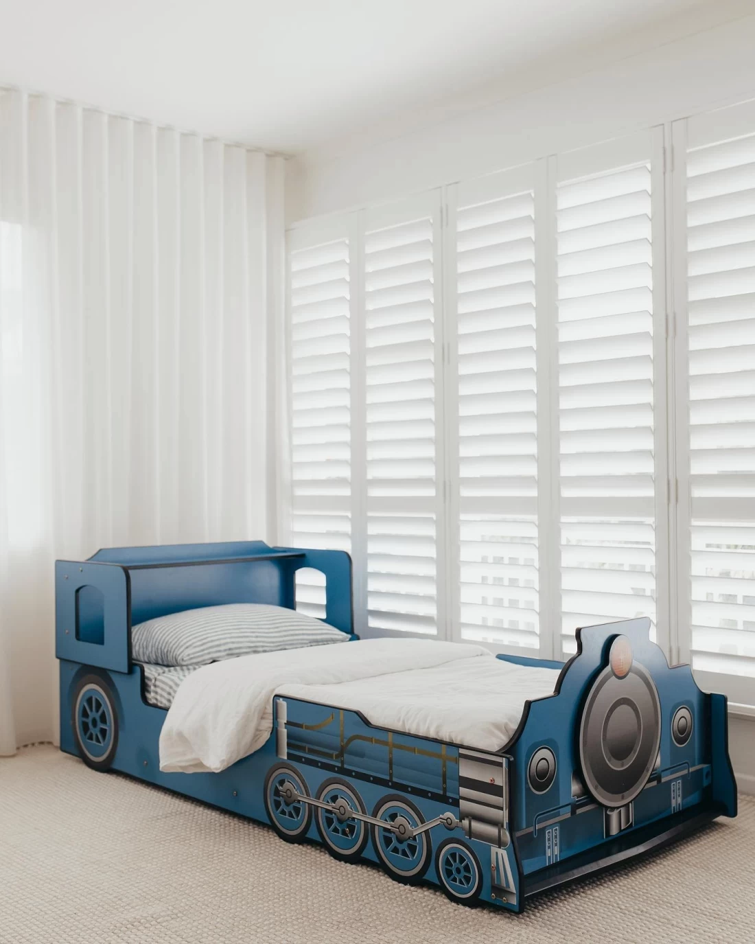Train-themed toddler bed displayed on a white background, showcasing the best toddler bed option.