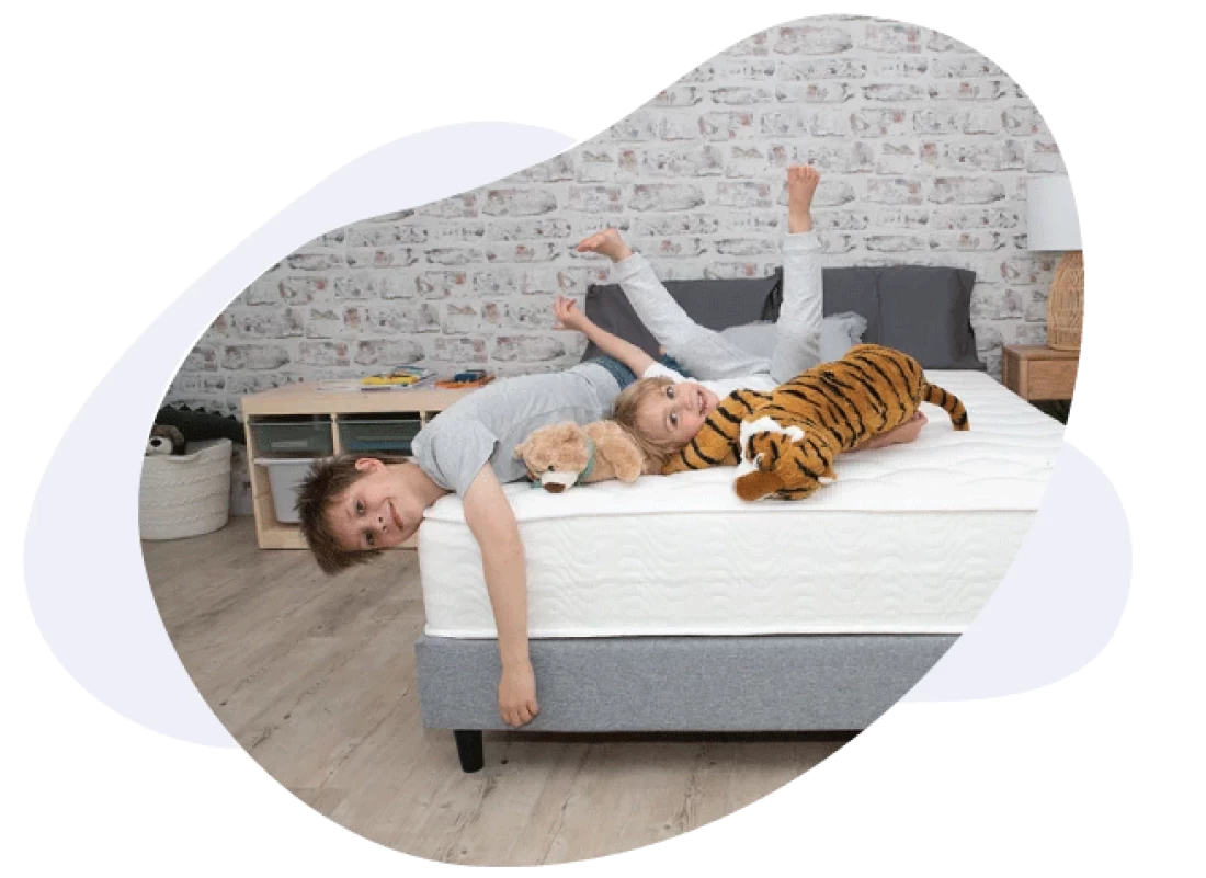 Toddler resting on a toddler bed, showcasing the best toddler bed for growing children.
