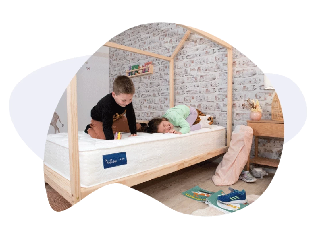 Two children enjoying a toddler bed, showcasing the best toddler bed for shared play and comfort.