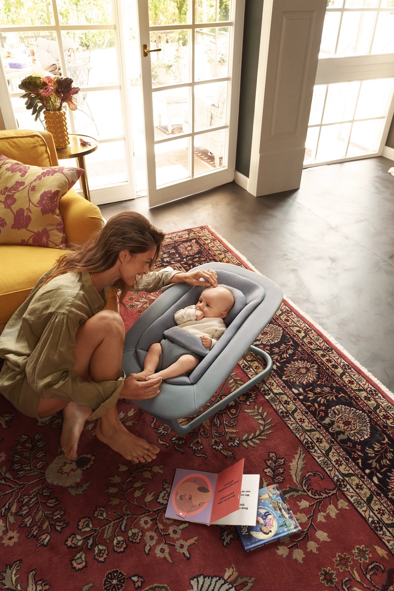 A baby in the cybex lemo high chair set up as the bouncer