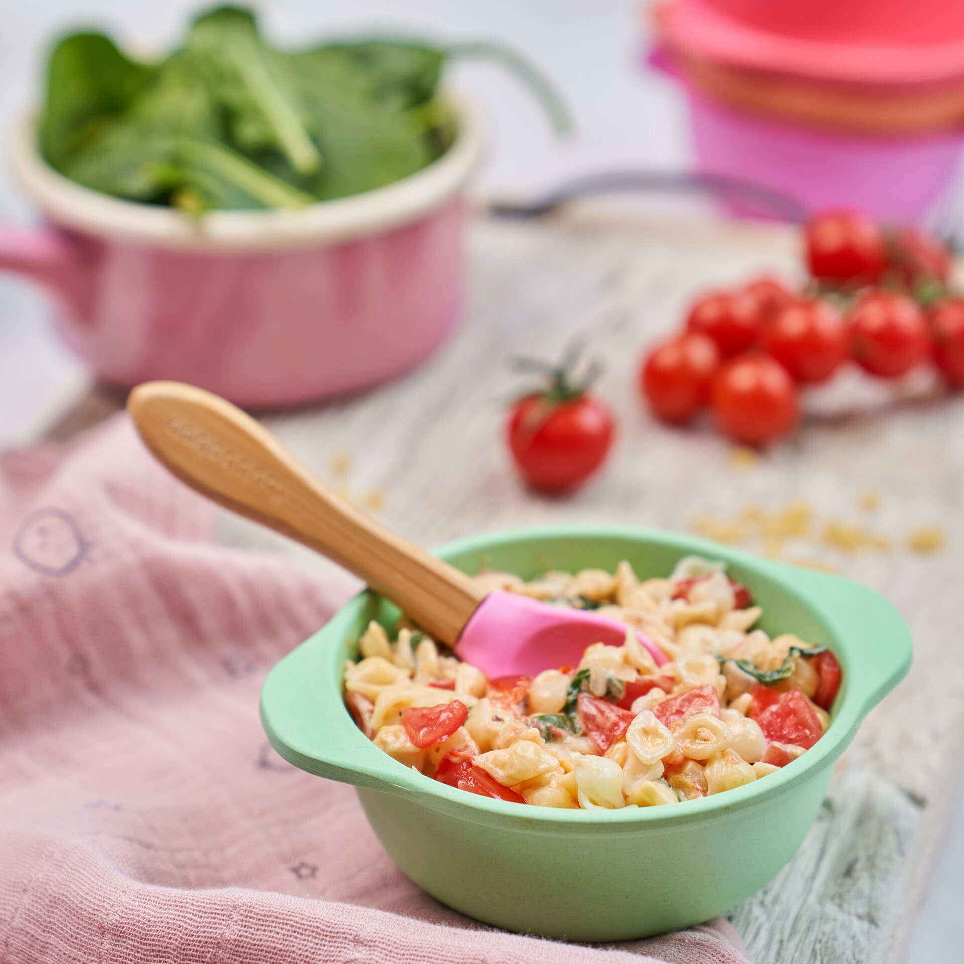 Green silicone bowl with wholesome baby pasta, demonstrating nutritious baby led weaning meals for babies.