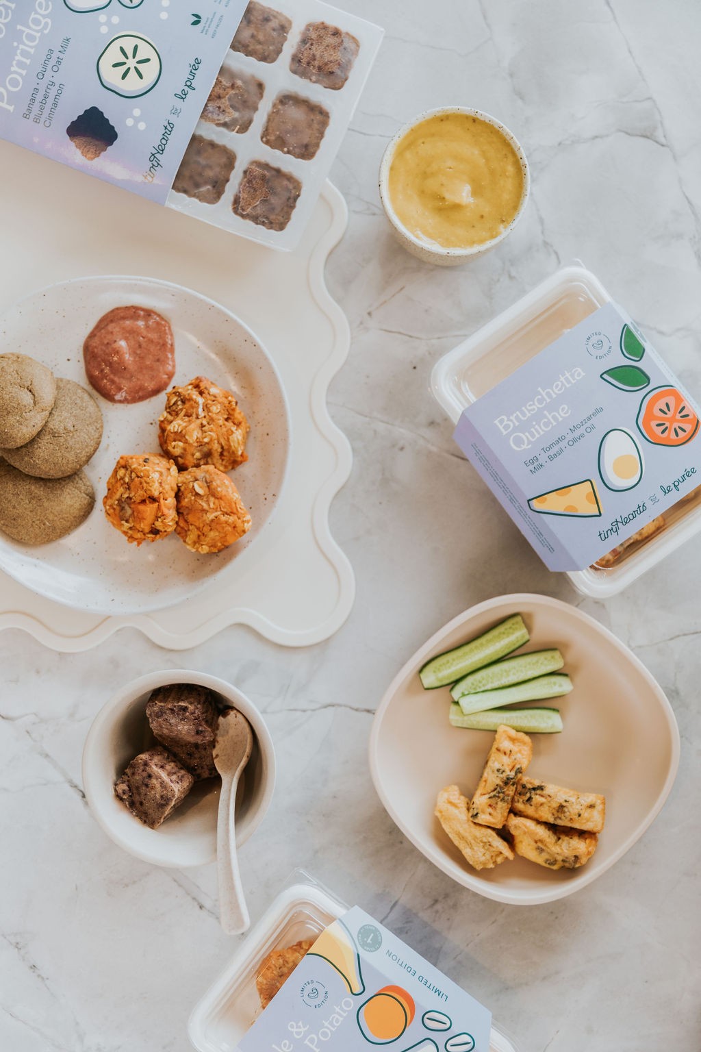 Baby-safe puree and finger foods arranged on a table, demonstrating strategies on how to prevent a baby from choking.