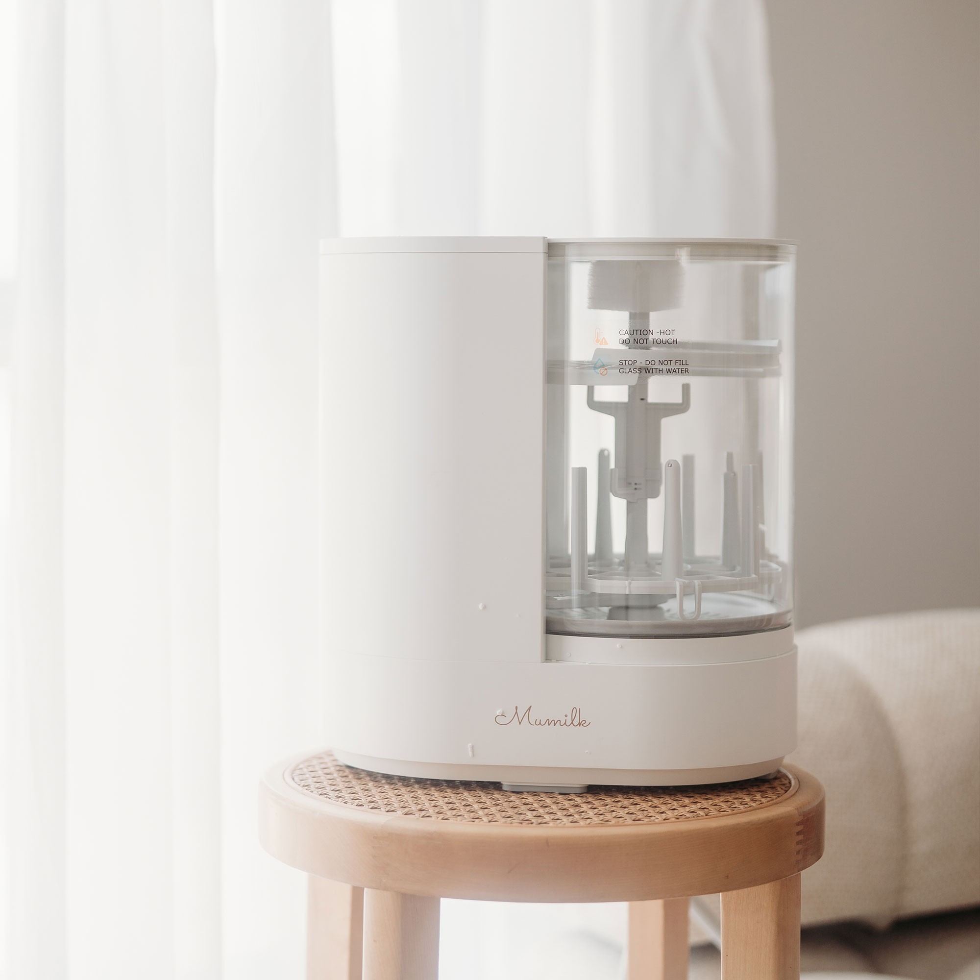 Compact white unit on tabletop – the best bottle steriliser designed to fit bottles, teats, dummies, and pump accessories.