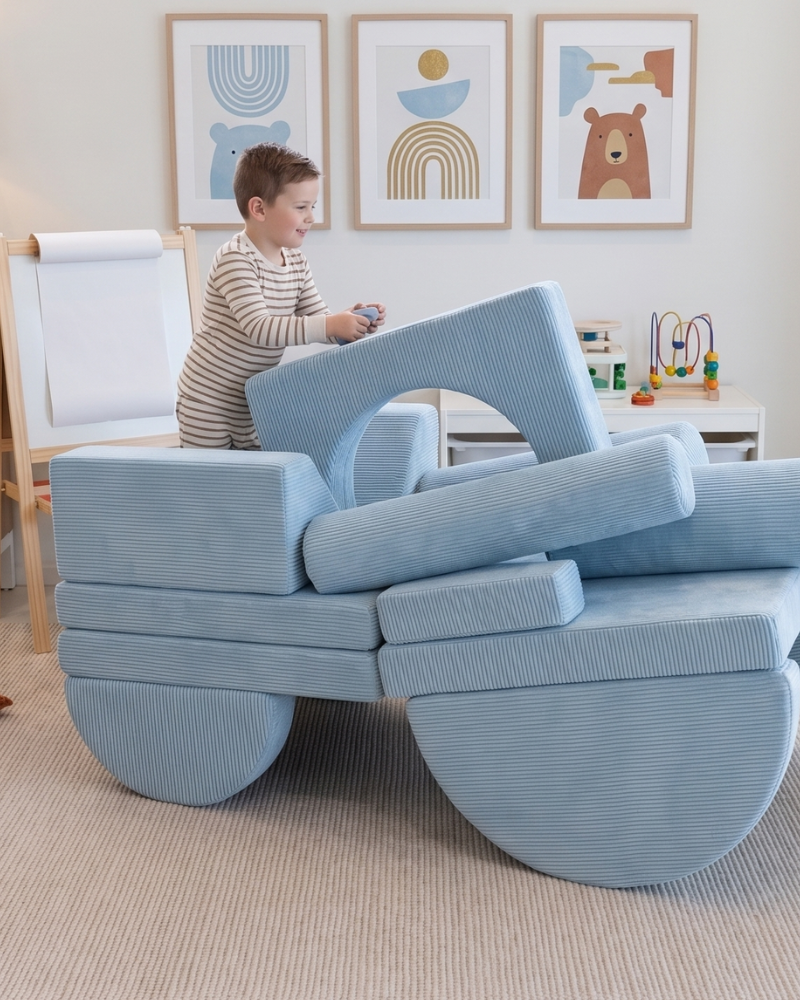 A boy playing on top of a Loungey play couch