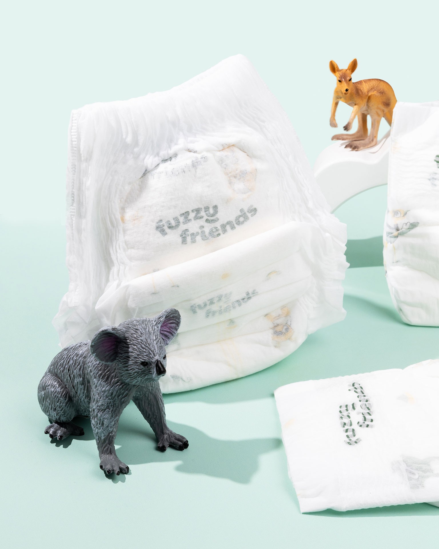 Display of a few diapers from Fuzzy Friend - best nappy brand in Australia​, with koala and kangaroo display toys
