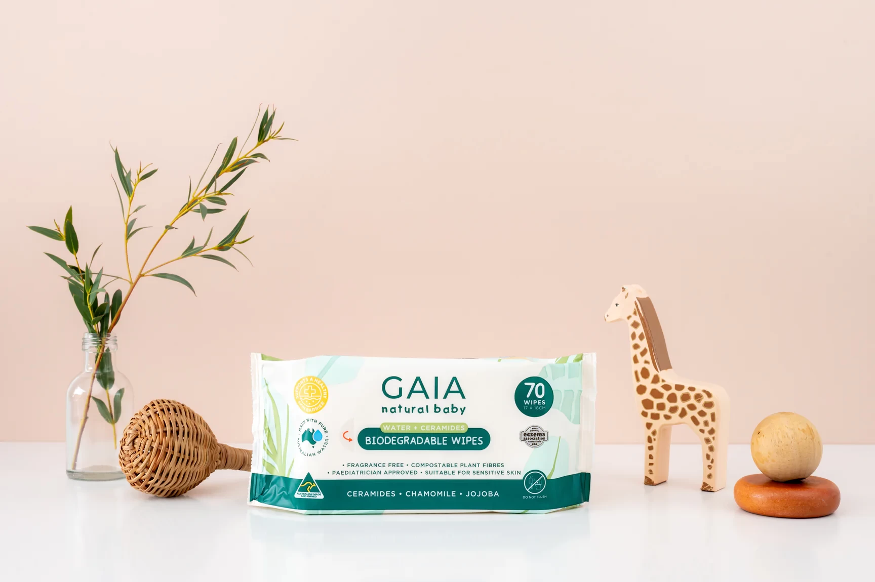 The gaia baby wipes set up with a plant and some toys