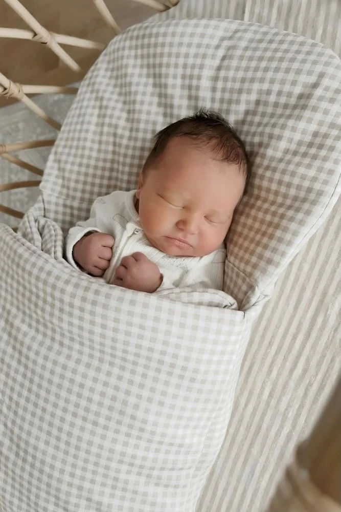 A baby asleep in the Bundle wool wrap