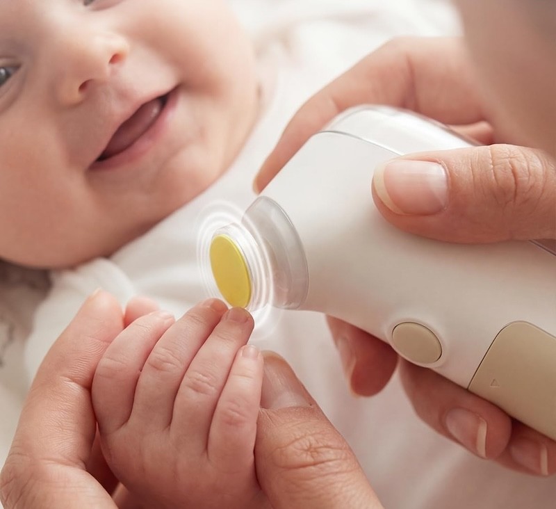 A baby having its nails groomed