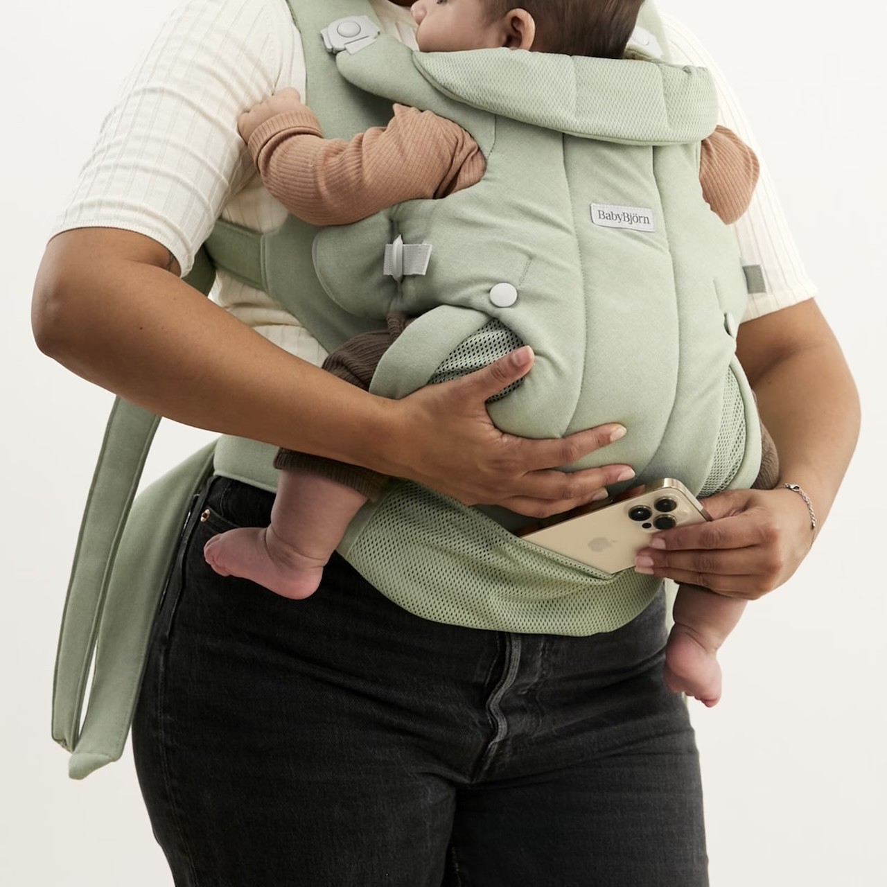 A mum putting her phone in the carrier's pocket