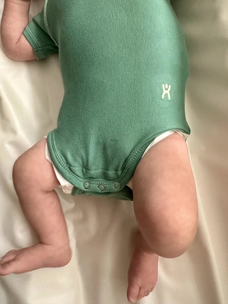 the flexisuit baby bodysuit on a newborn