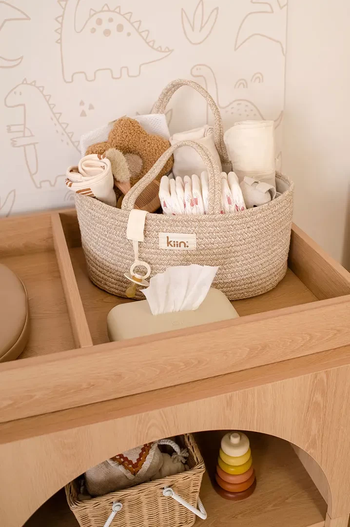 Best nappy caddy organiser by Kiin alongside rattan nursing caddy on baby changing station – neatly packed with nappies, creams and wipes