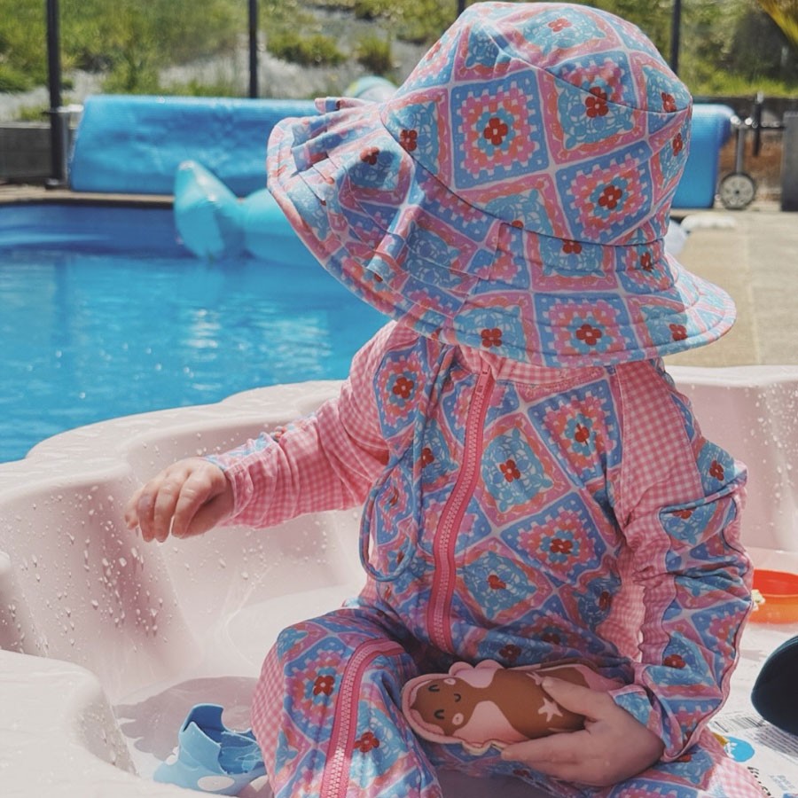 Baby playing on a pool floatie in Tyoub eco-friendly baby and toddler best swimwear