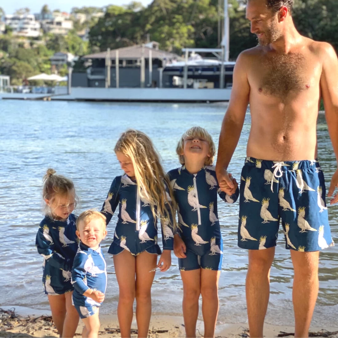 Dad and kids in coordinated Cheeky Chickadee best swimwear enjoying time outdoors