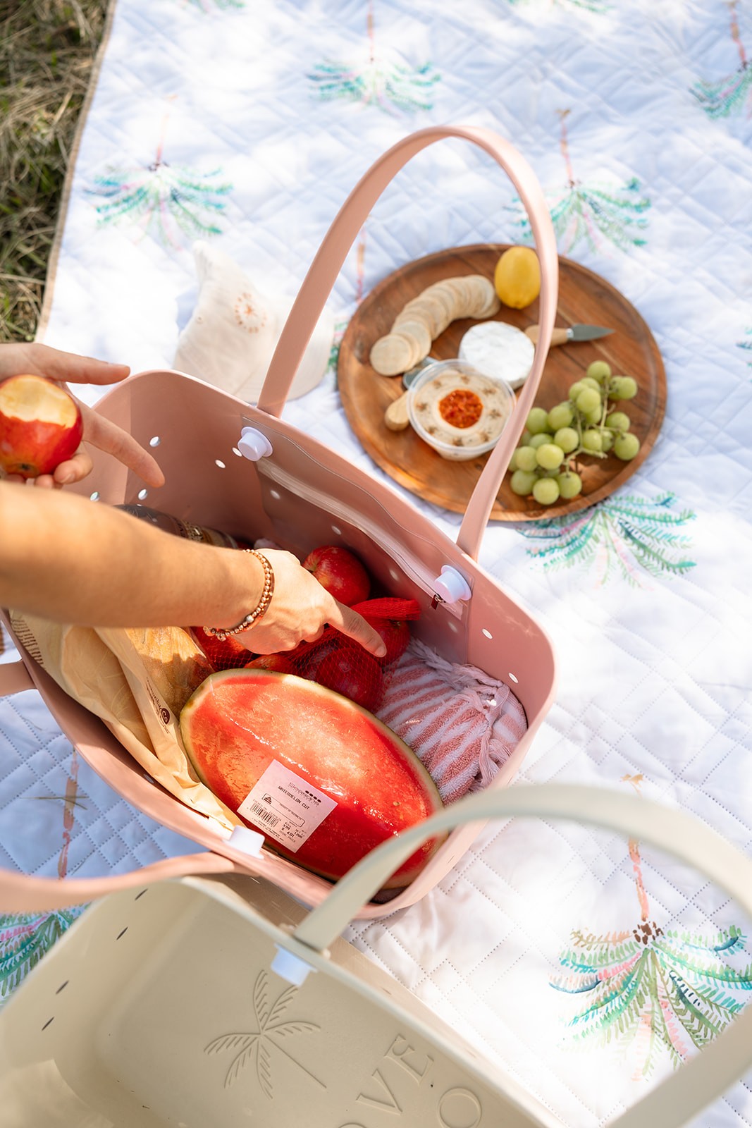 Best beach bag by Kove & Co at the picnic park, packed with snacks, fruit, and drinks