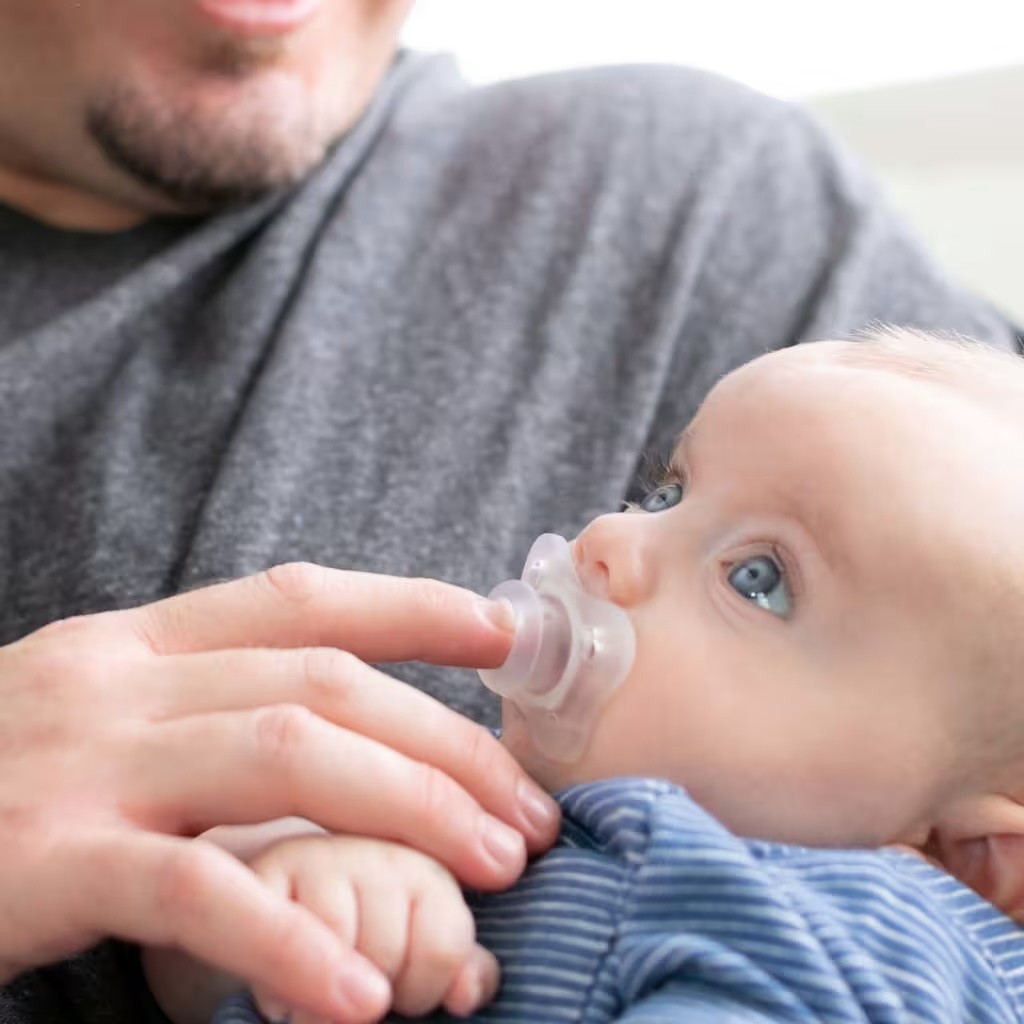 A mum putting a Chicco Physio dummy into her baby's mouth