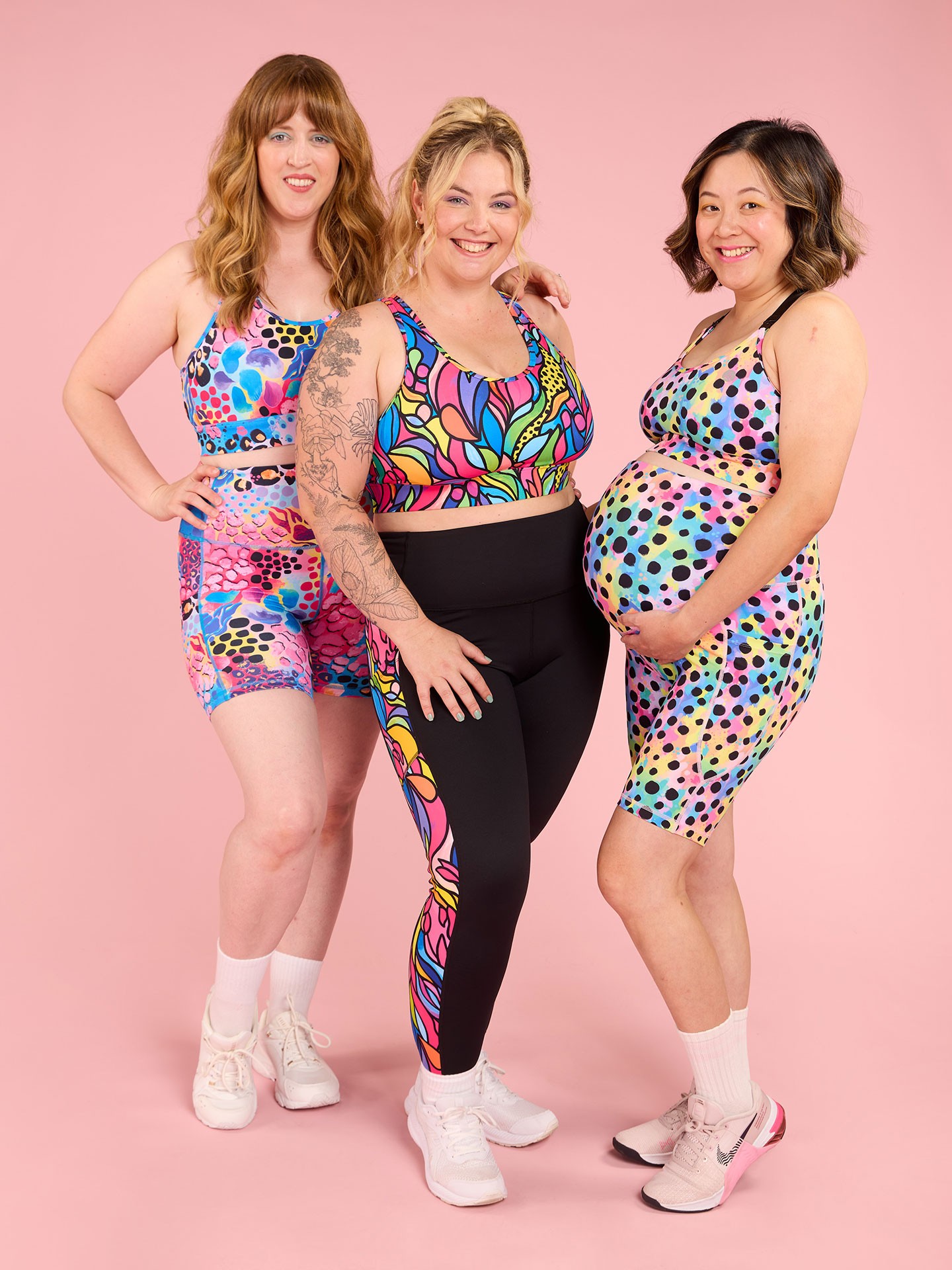 Three happy pregnant mums wearing Mama Movement best maternity activewear in different prints, smiling and comfortable.
