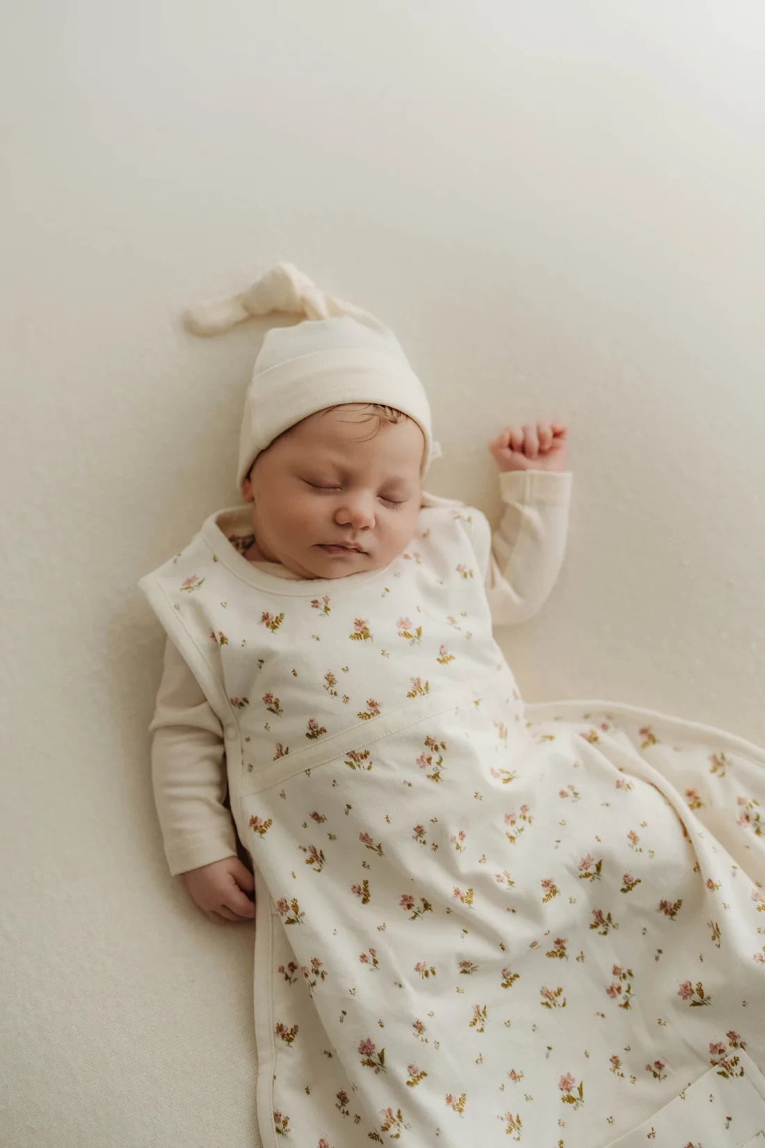 A baby asleep in the merino kids summer baby sleeping bag