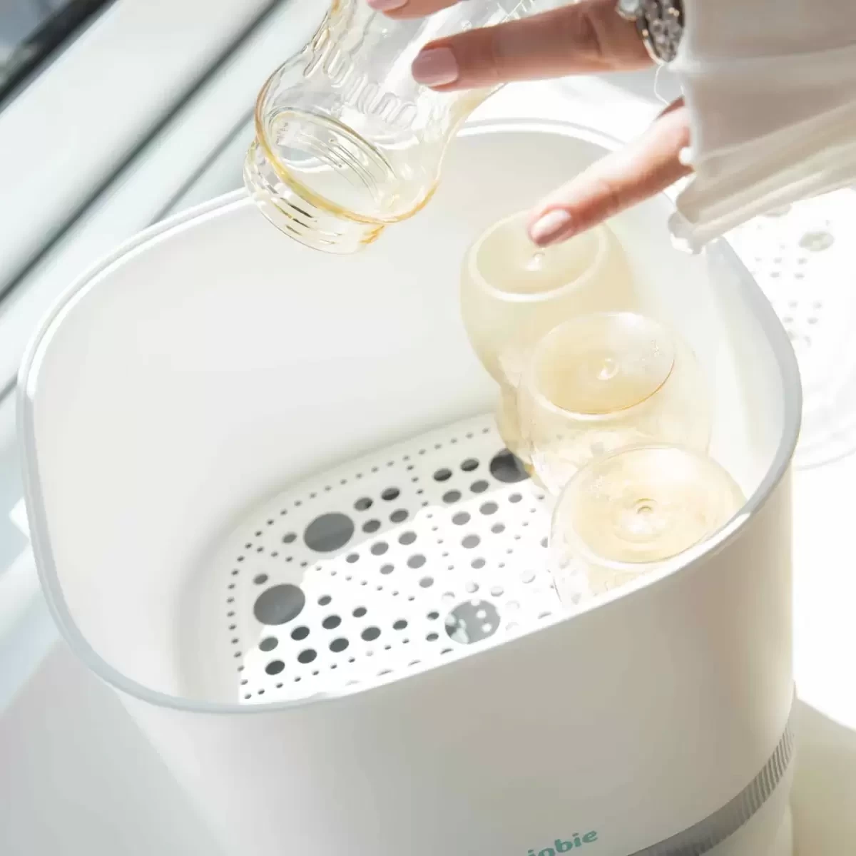 a baby bottle steriliser with bottles in it
