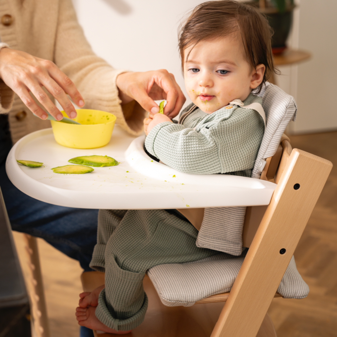 Tripp Trapp best baby high chair used by mum during feeding time with her infant