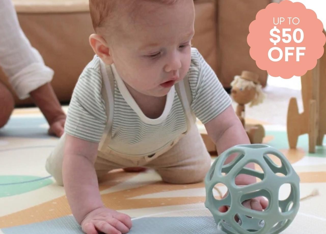 a baby playing on a play mat