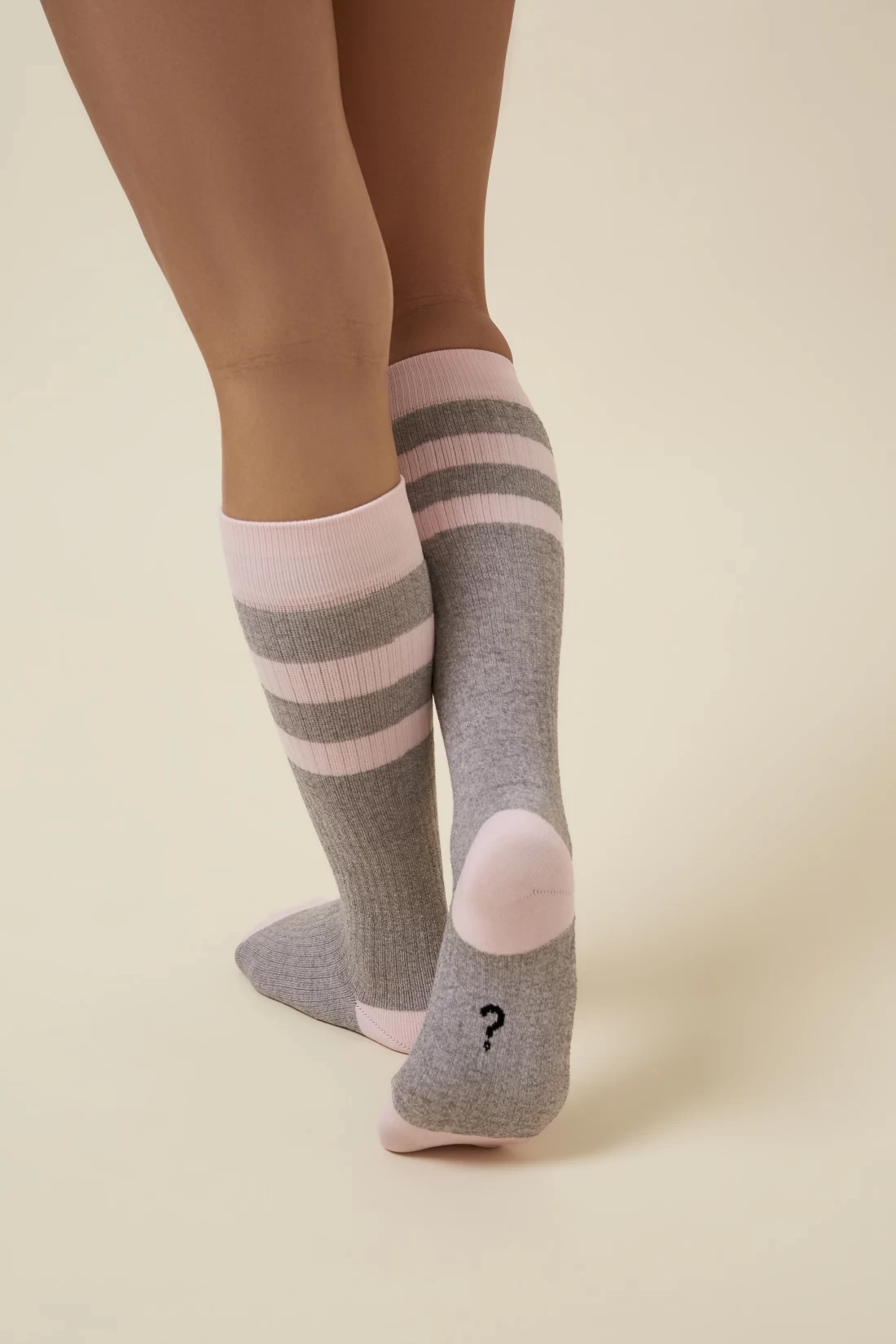 A mum walking while wearing Thery The Reason Why The Comforter Compression Sock — a must-have item when deciding what to pack in the hospital bag for postpartum comfort.