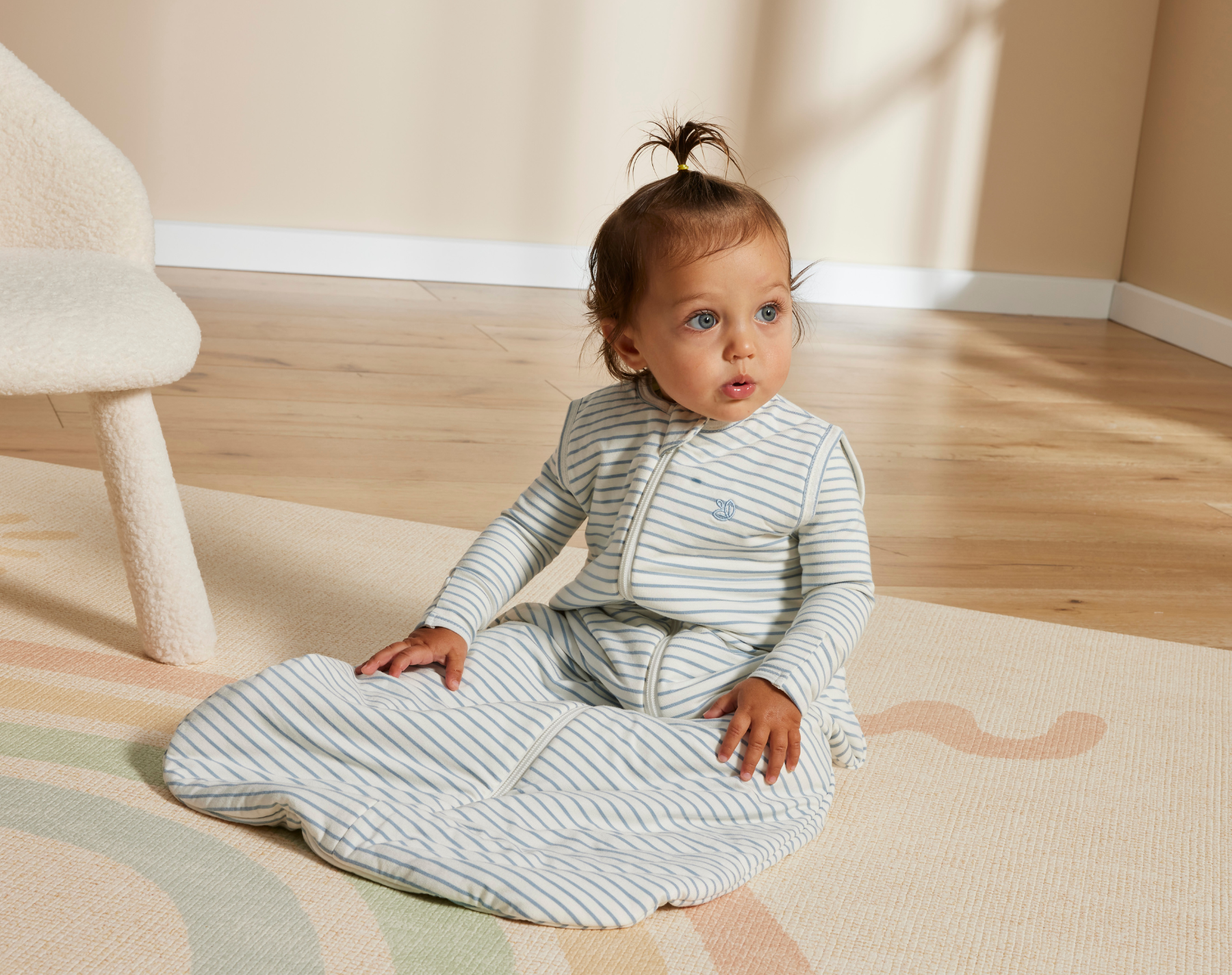 Baby in Grow Kindly sleeping bag – close-up showing quality stitching and cosy materials.