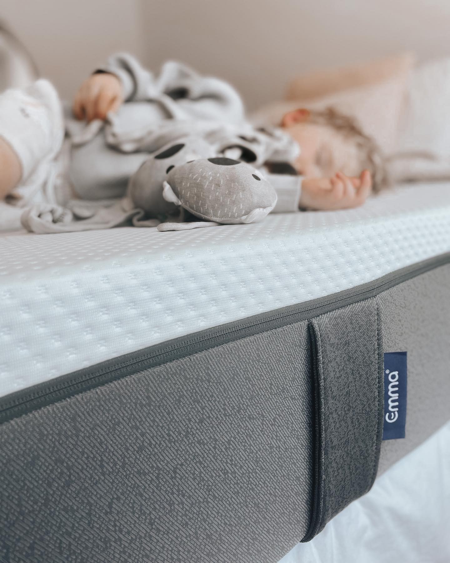 Infant sleeping on a well-designed toddler bed, showcasing the best toddler bed for growing children.