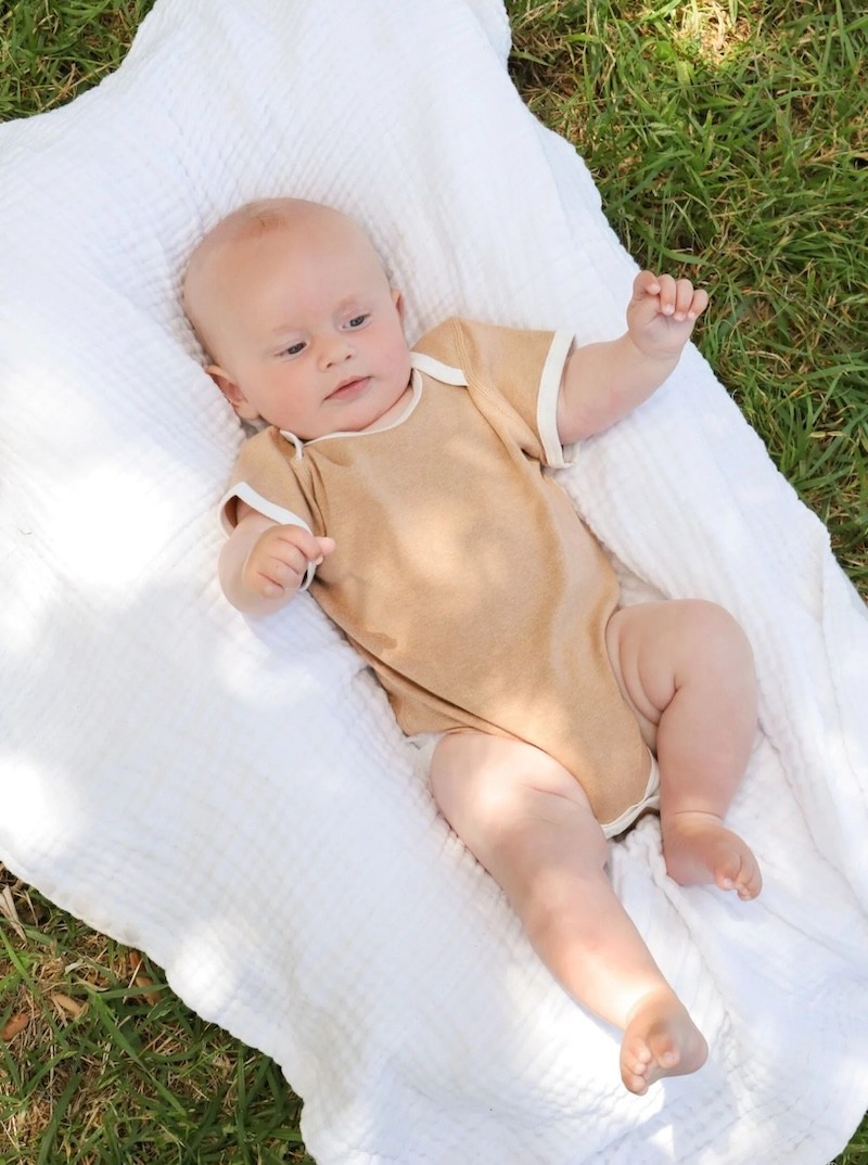 Fibre for good short sleeve baby bodysuit in a neutral colour