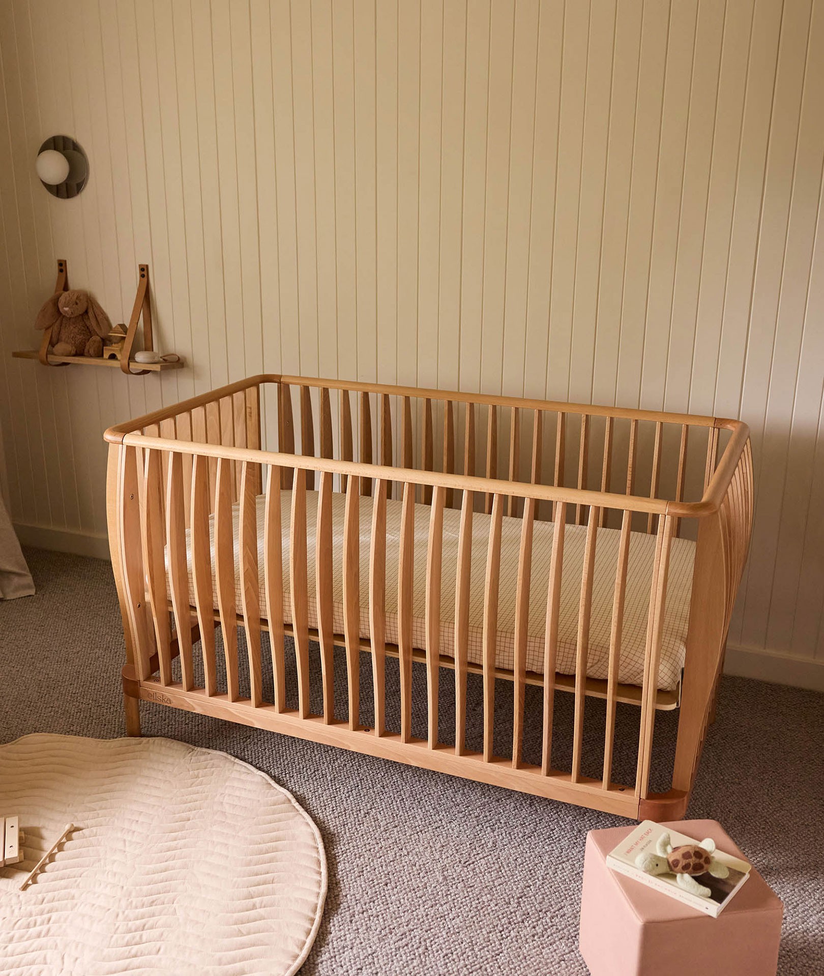 Best baby cots Australia, natural beechwood ErgoPouch cot inside a baby room with adjustable mattress heights and convertible toddler bed design