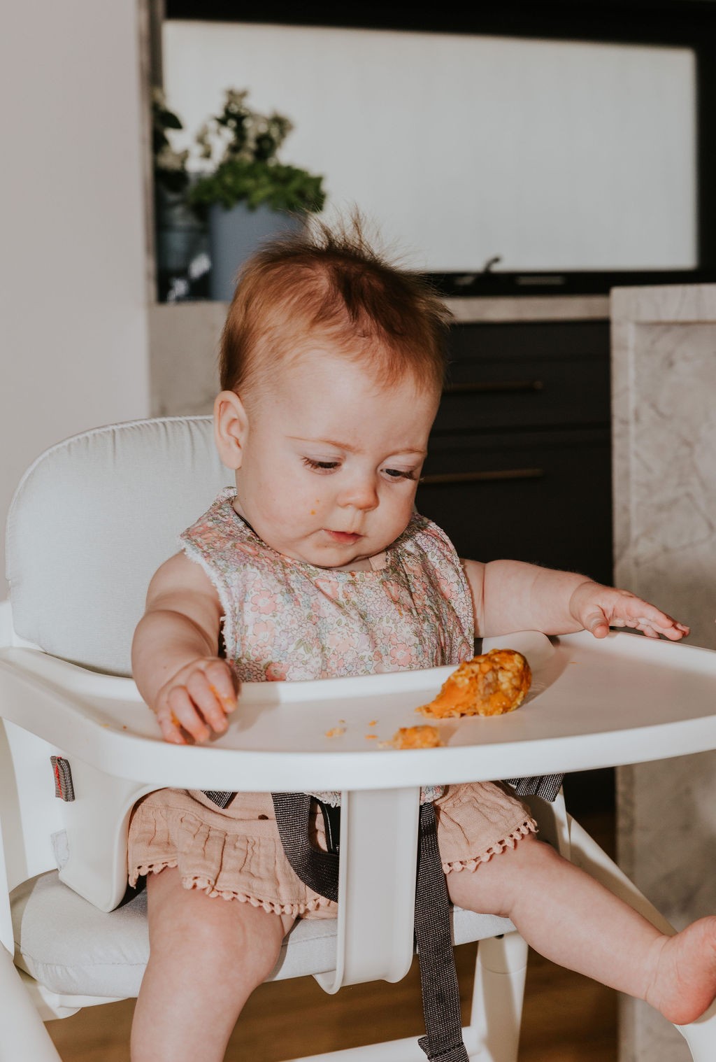 Baby eating on the table, demonstrating safe practices on how to prevent a baby from choking.
