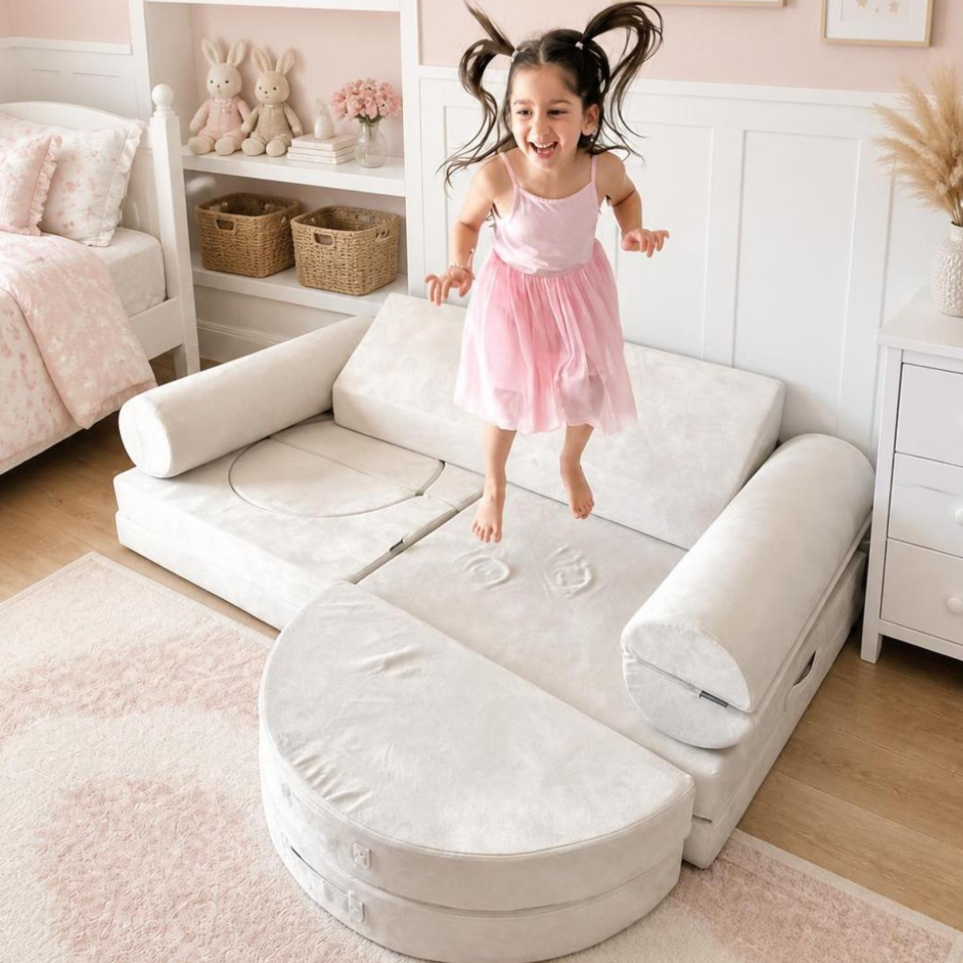 the Luxe 14 Ivory play couch by loungey with a toddler jumping on it