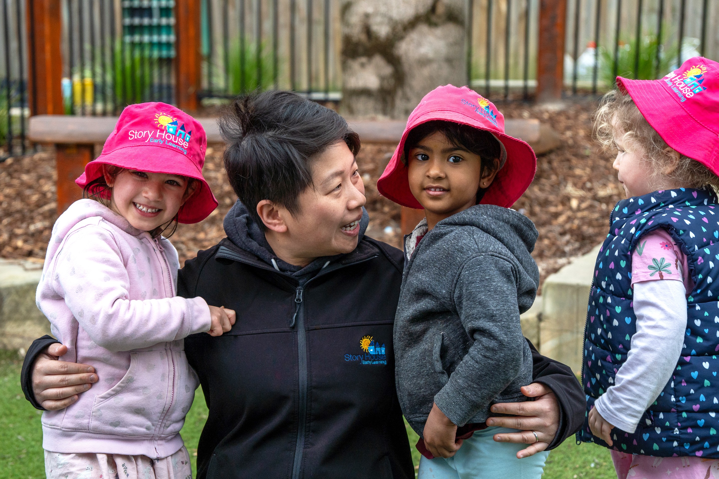 Caring educator spending time with children at the best childcare service centre.