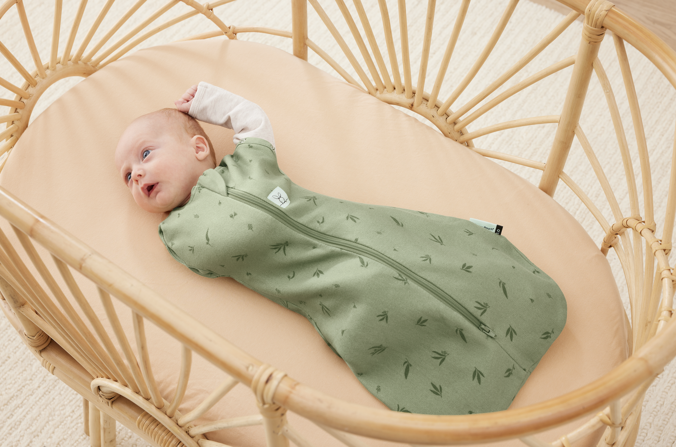 Awake newborn wearing Ergopouch Cocoon Swaddle Bag – gentle, breathable swaddle for safe sleep and easy mornings.