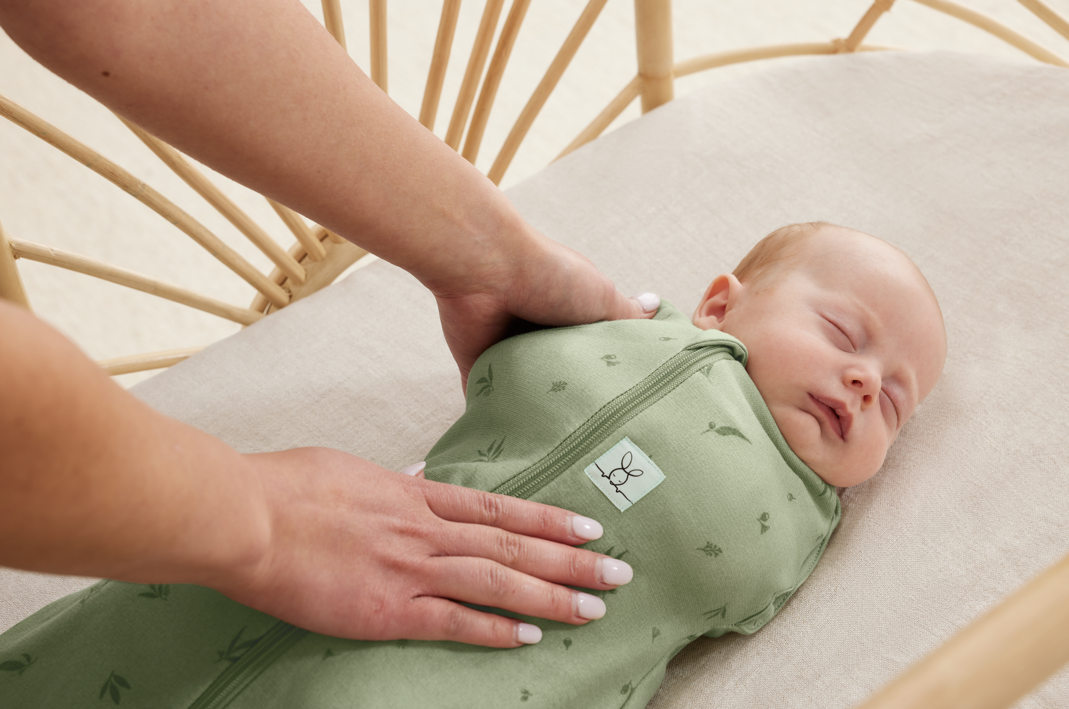 Newborn sleeping peacefully in Ergopouch Cocoon Swaddle Bag – designed for safe and snug sleep.