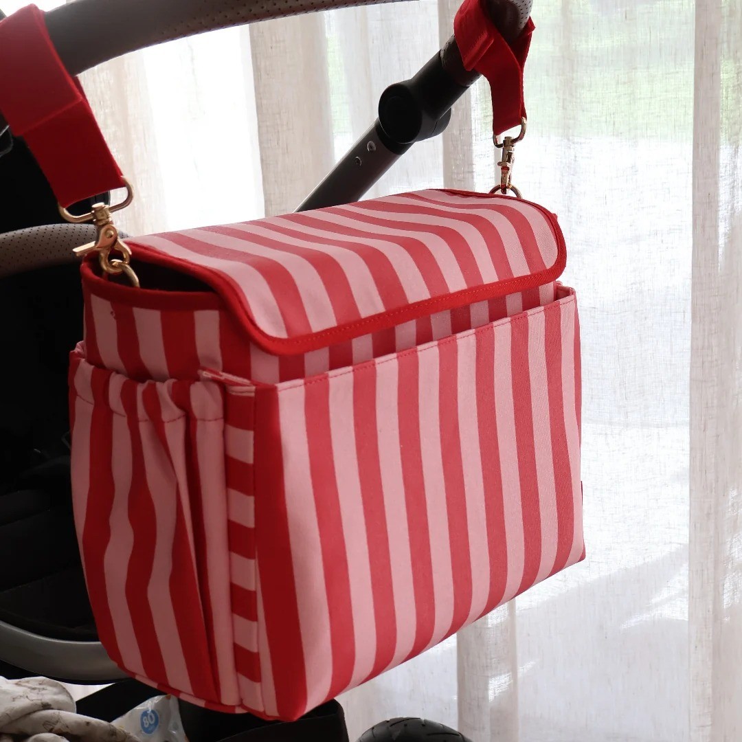 the bon maxie pram caddy in pink and red stripe