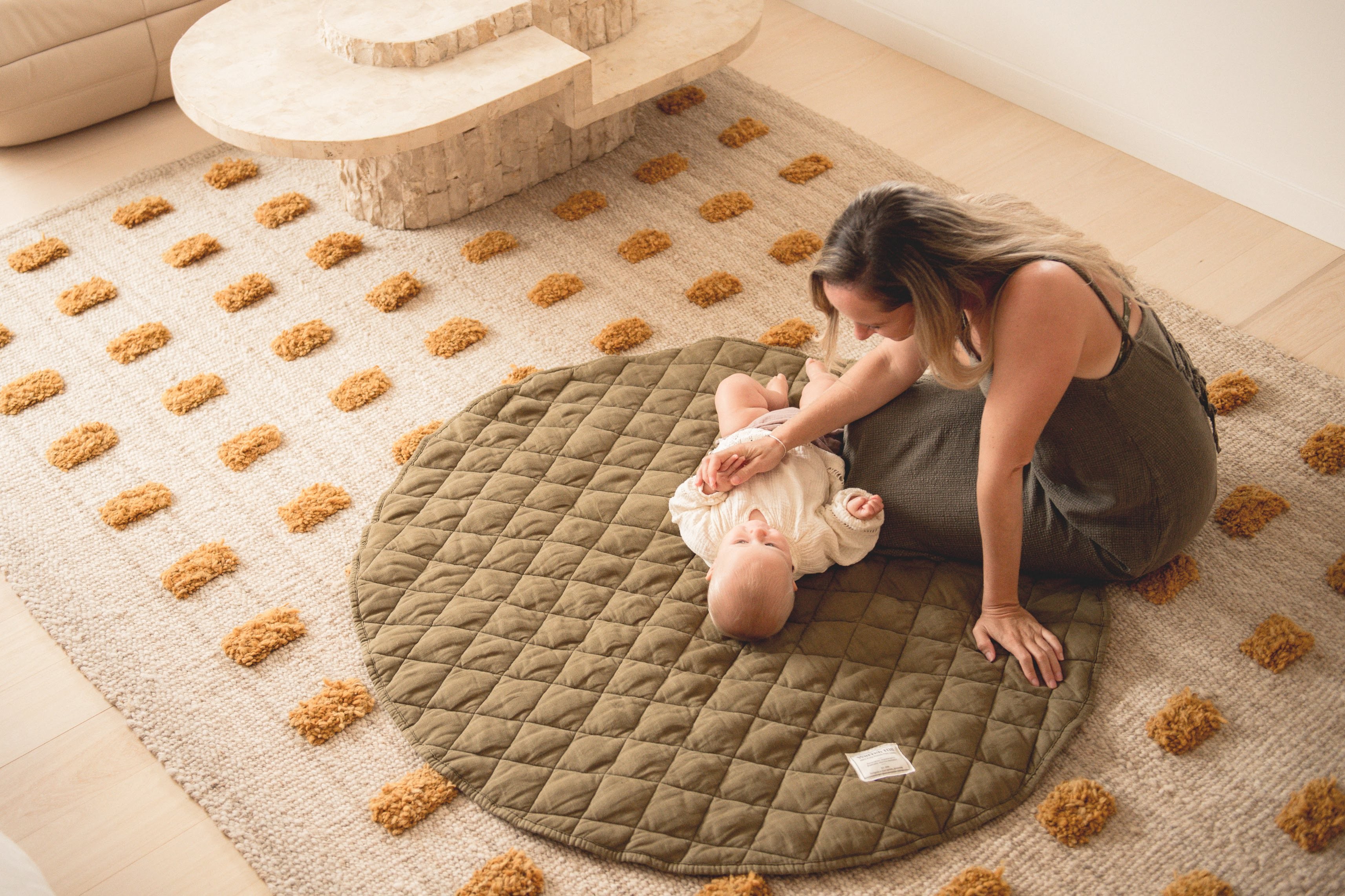 "Mother and baby playing together on Warren Hill Linen Play Mat in cosy home setting
