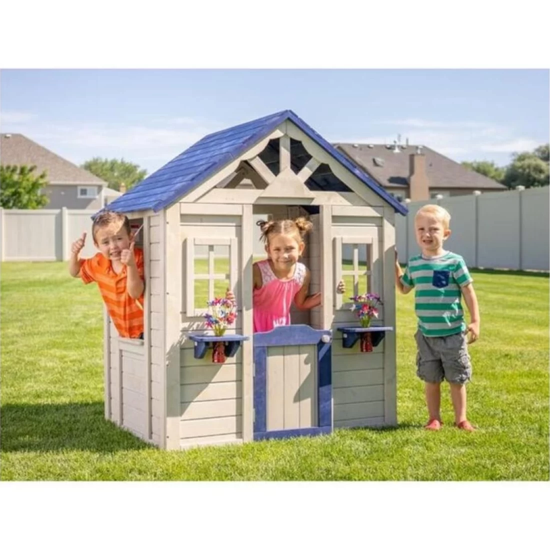 Three children enjoying their time inside a best cubby house posing for a picture