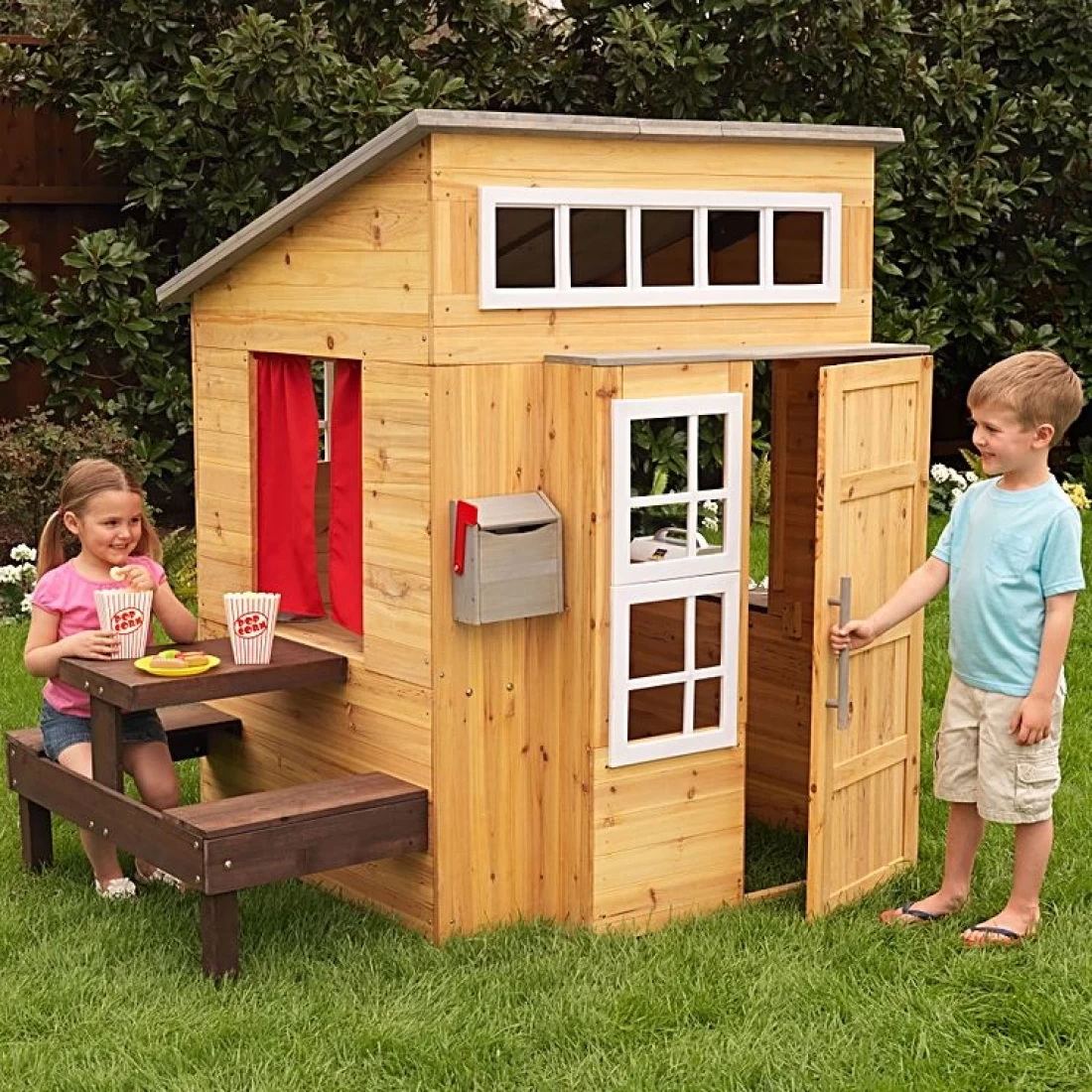 A wooden best cubby house with two kids playing perfect for imaginative outdoor play