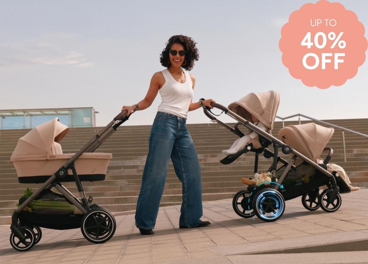 A mum pushing two CYBEX prams