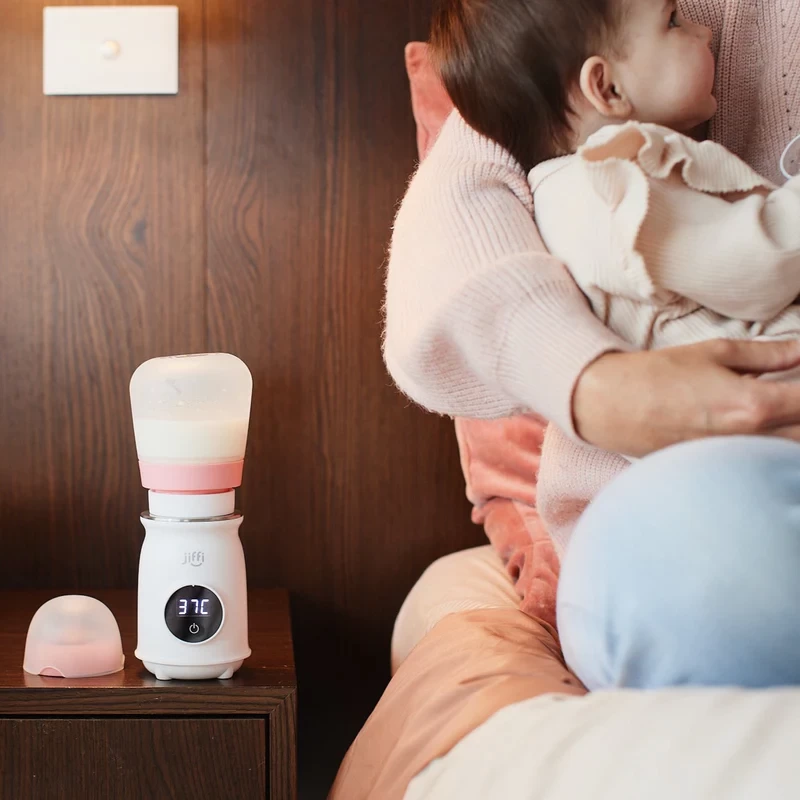 The Jiffi bottle warmer on a bedside table next to an Australian mum and baby