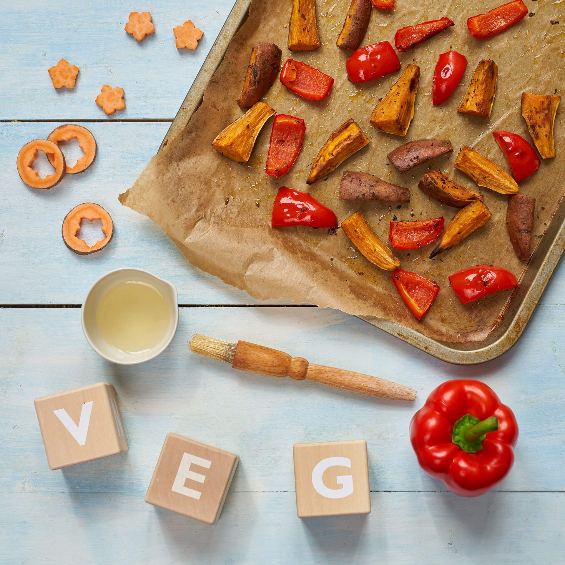 Baked sweet potato and pepper wedges on a tray