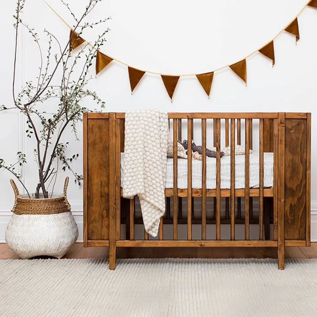 Best Baby Girl Nursery Ideas with bohemian style décor featuring neutral tones and rattan accents.
